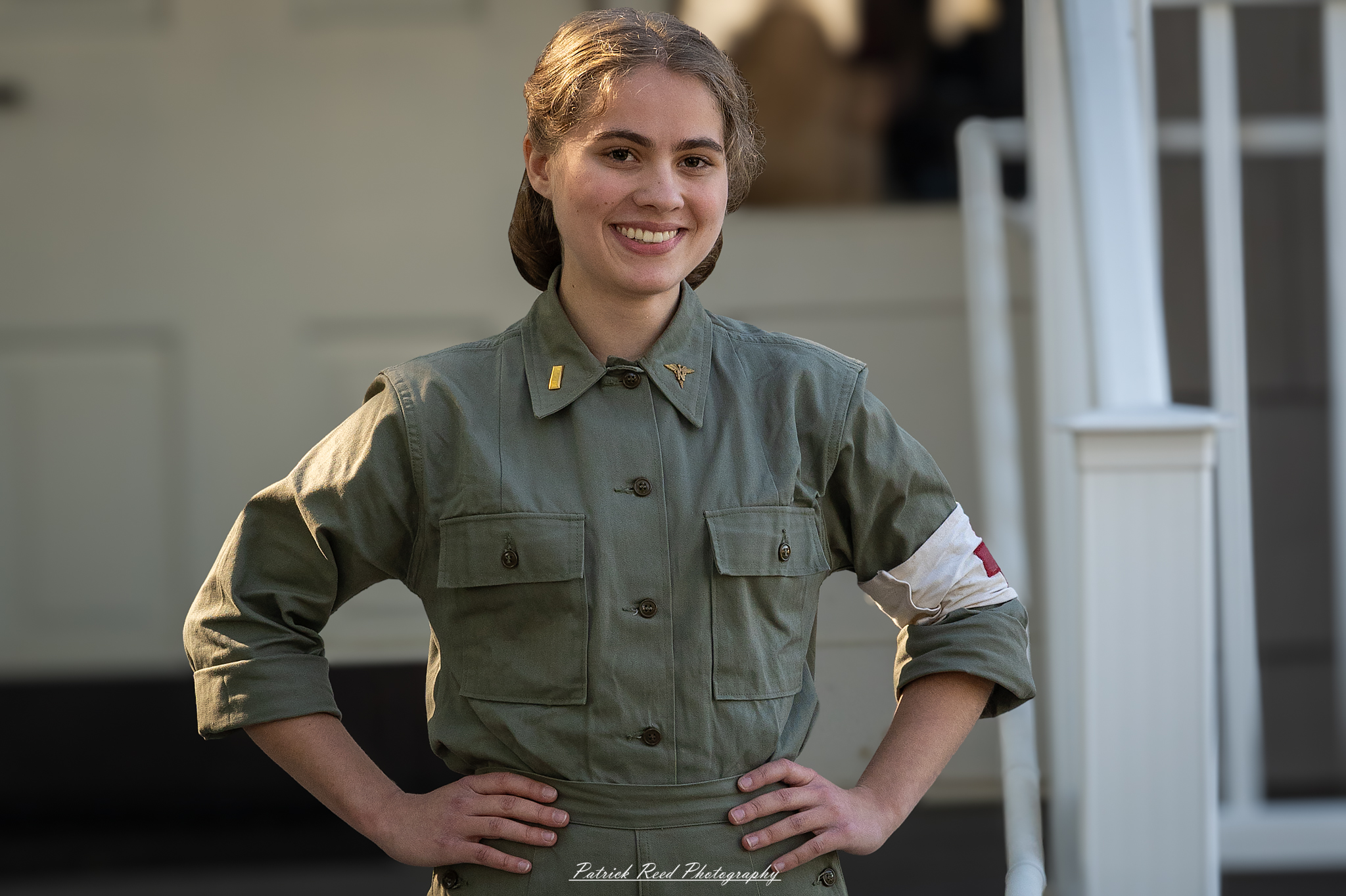 "Portrait of a U.S. female medic in a WWII-era military setting. She is dressed in a standard military uniform with a red cross armband, showcasing her role in providing medical assistance. Her expression is determined yet compassionate as she tends to a soldier in need. The background features a field hospital with medical supplies and equipment, illustrating the challenges and dedication faced by women in military medicine during the war."